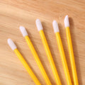 Pack of disposable lip brushes with flocked heads and coloured handles, shown in quantities from 200 to 500 pieces.