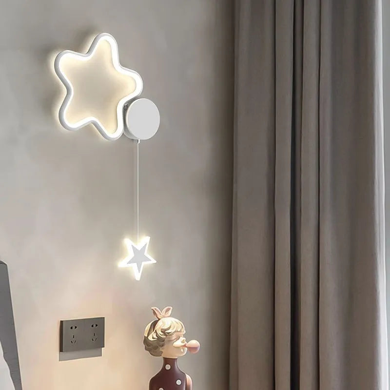 Cartoon cloud, moon and five-pointed star shaped bedside wall lamp for a children's bedroom in black or white.
