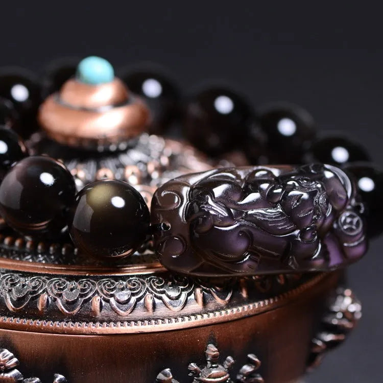Polished crystal Pi Xiu bracelet on wrist, showing ethnic geometric style and Icy Obsidian colour.