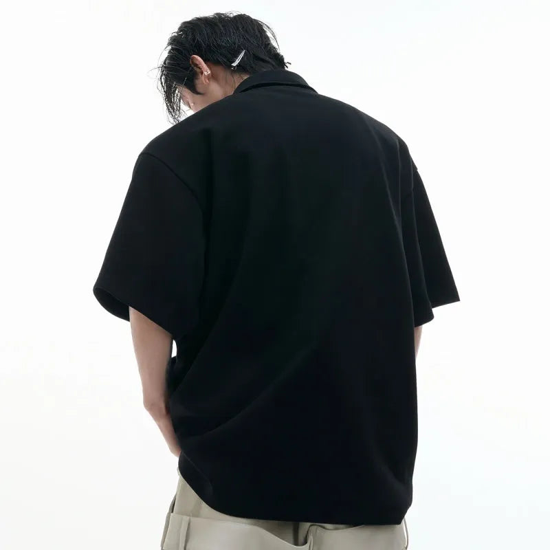 Men's black polo shirt with deconstructed collar and white Giant Land Turtle geometric graphic.