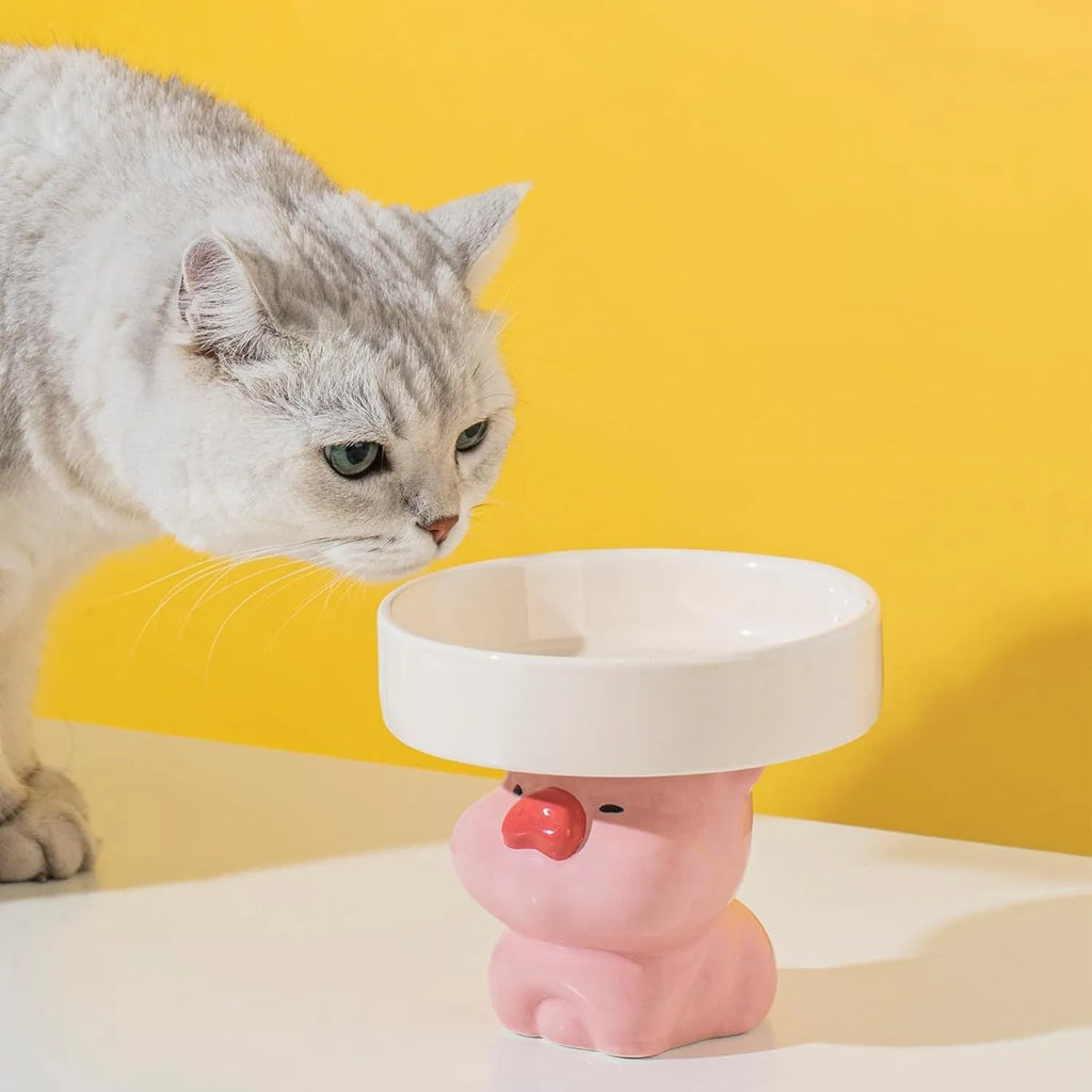 Ceramic raised cat bowl with cute animal design, shown in pink pig, white bear, and yellow duck styles.