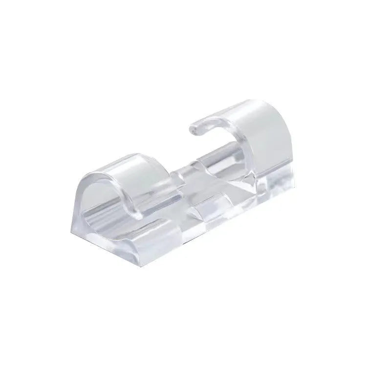 Transparent plastic self-adhesive cable management clips in four sizes on a white background.
