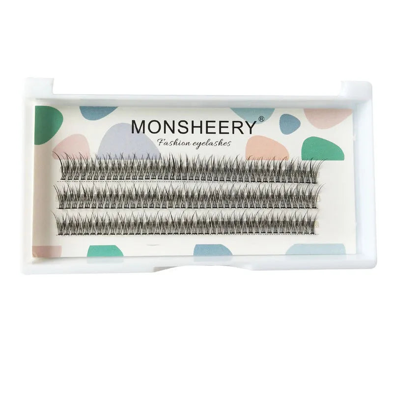 Black V-shaped fairy fishtail false eyelashes with thick segments in varying lengths on a clear tray.