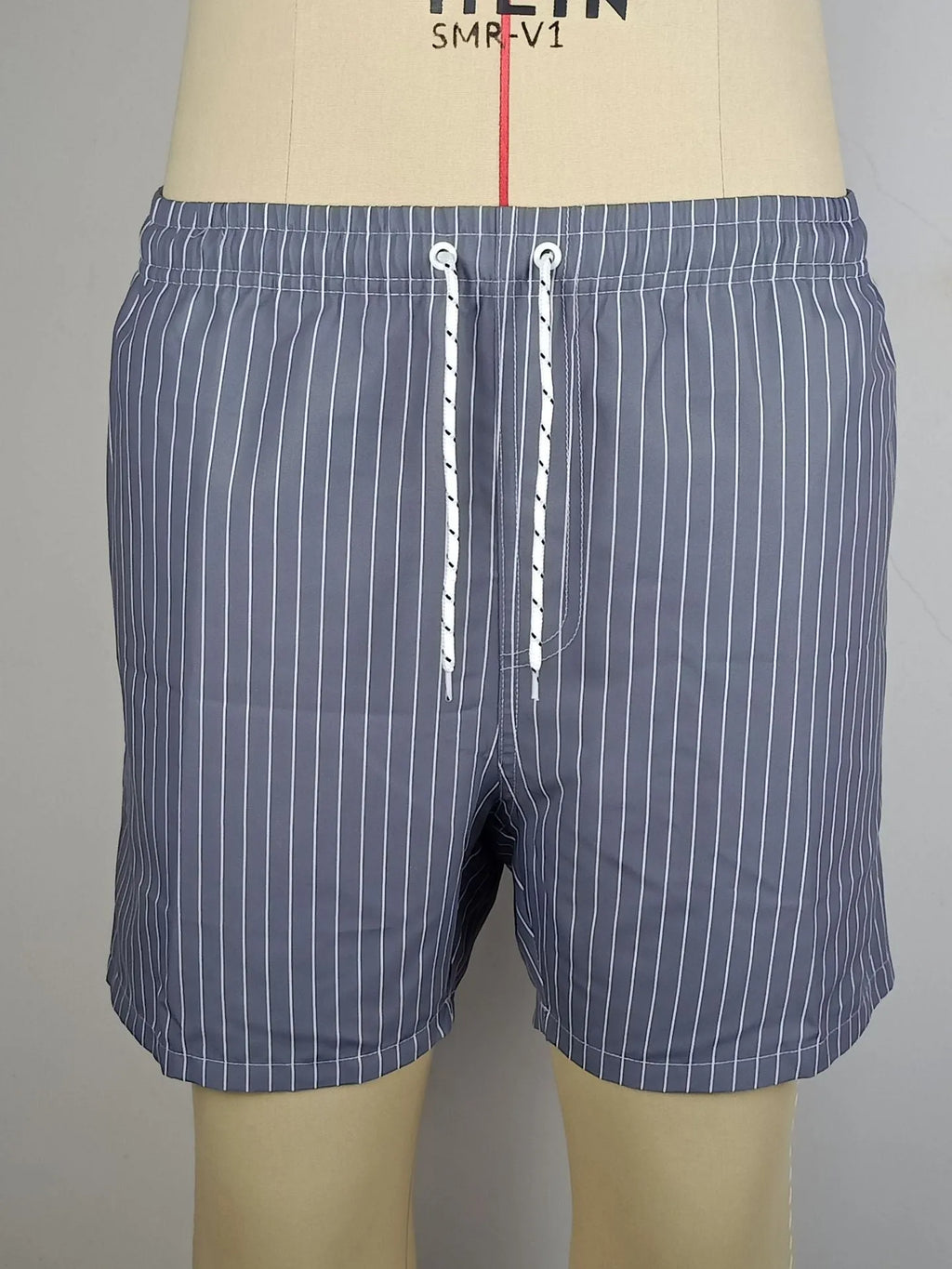A pair of grey striped casual shorts with a straight leg opening, laid flat.