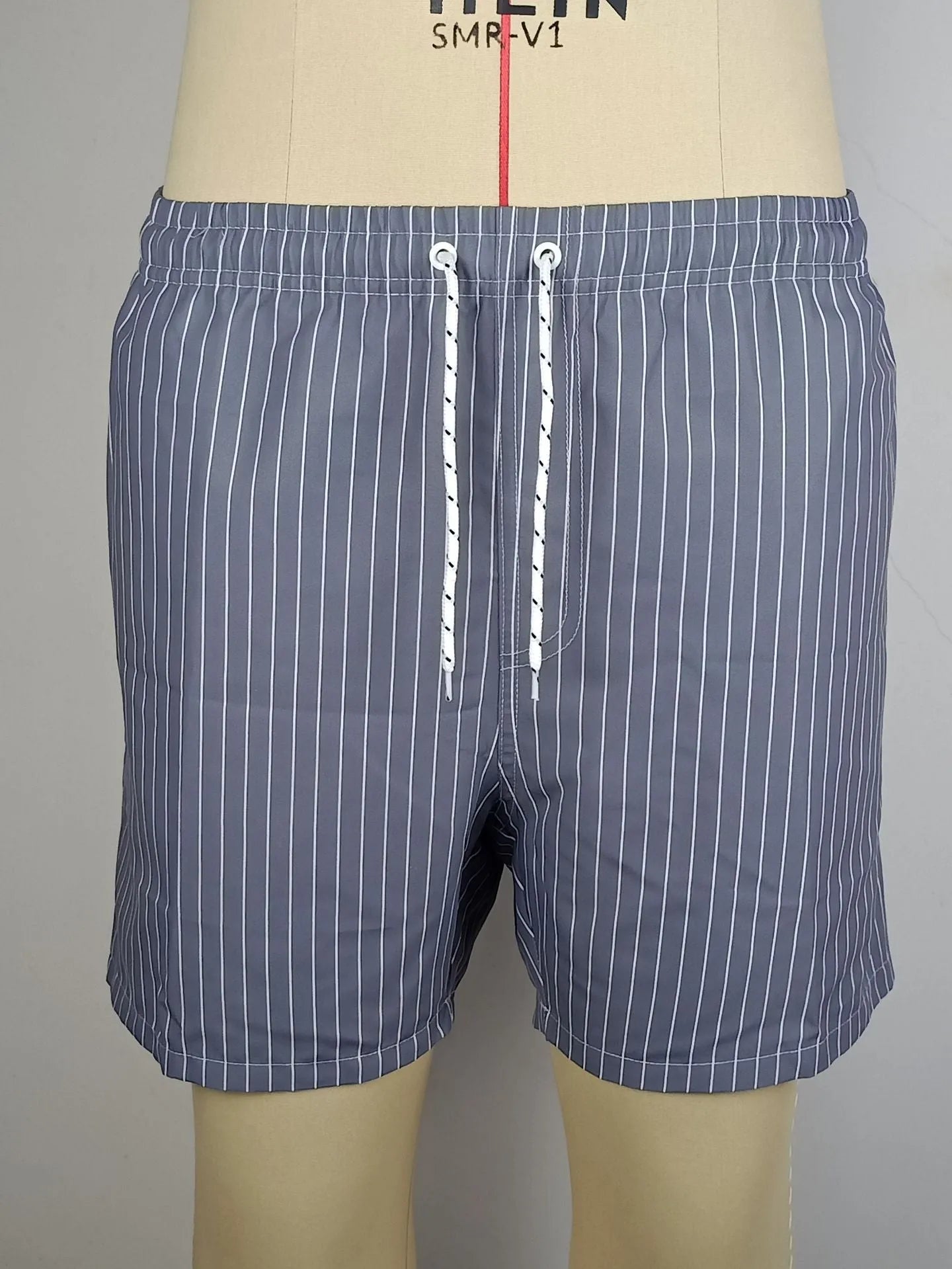 A pair of grey striped casual shorts with a straight leg opening, laid flat.