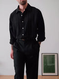 Black pinstriped button-down shirt with regular fit on a hanger