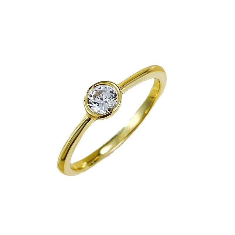 Minimalist silver crown-shaped ring with linear details, shown in gold and platinum finishes.