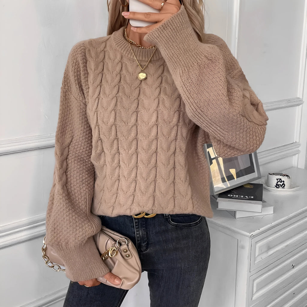 Women's loose beige round neck casual sweater with textured thread detail on a hanger.
