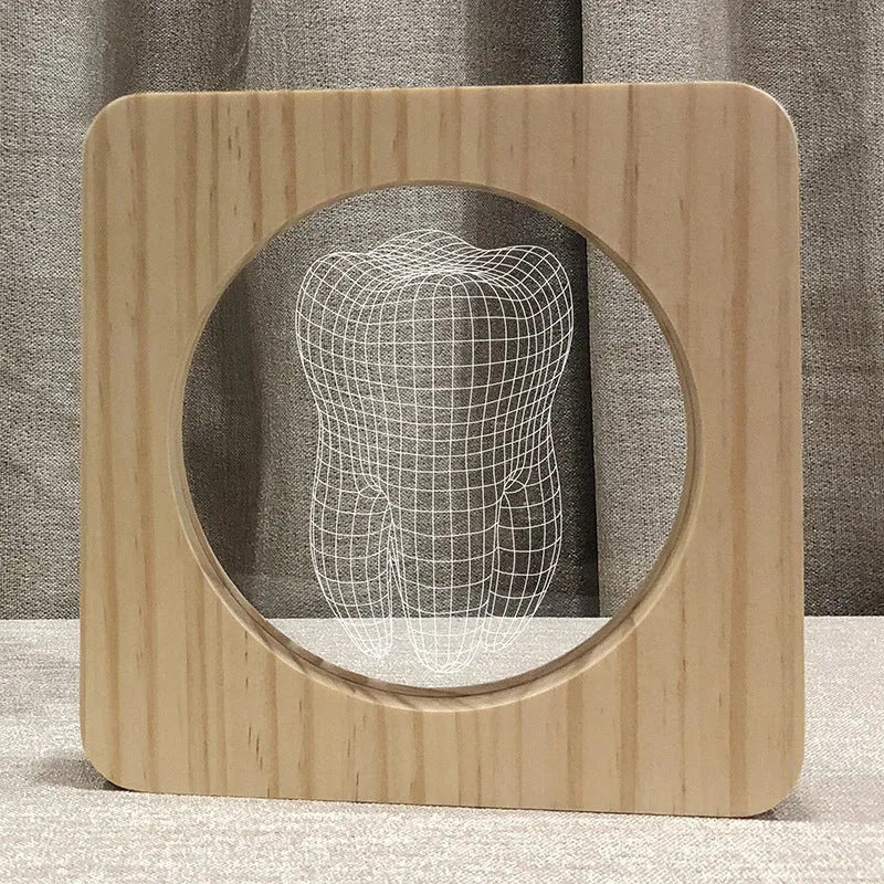 Wood colour tooth-shaped acrylic night light on a surface with a USB cable.