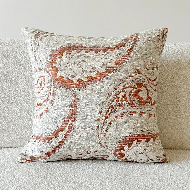 American-style jacquard paisley decorative pillow cover in amber tones on a sofa, showing square and rectangular size options.
