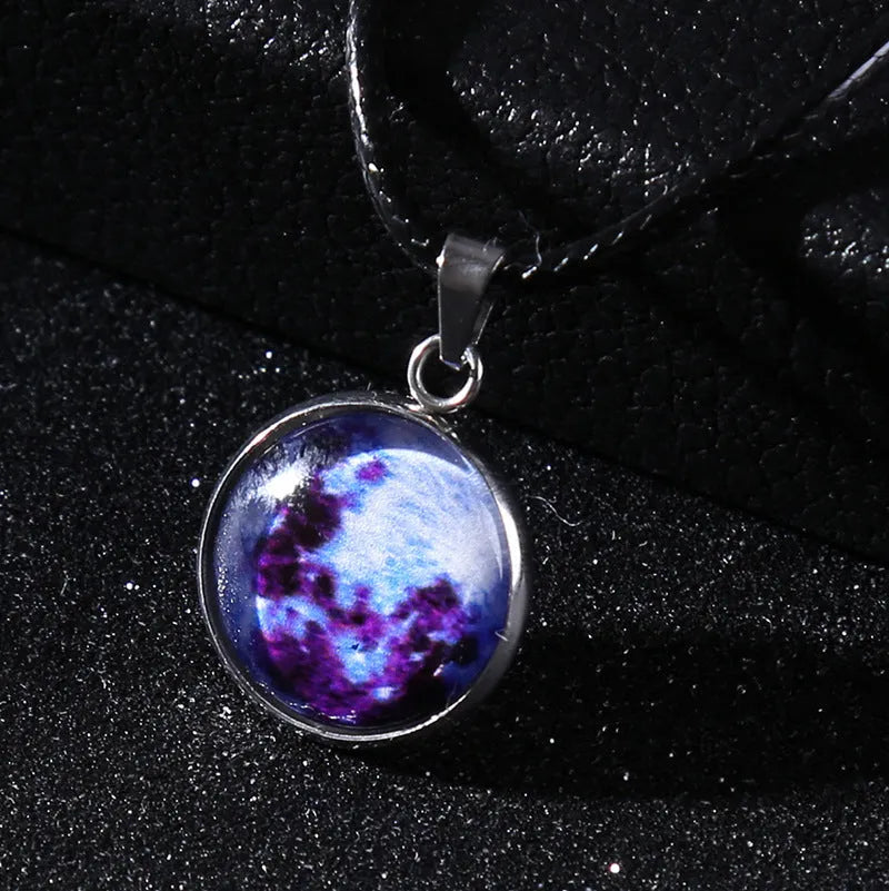 Luminous moon and constellation pendant necklace on a chain with an extension, shown in one of ten possible colours.