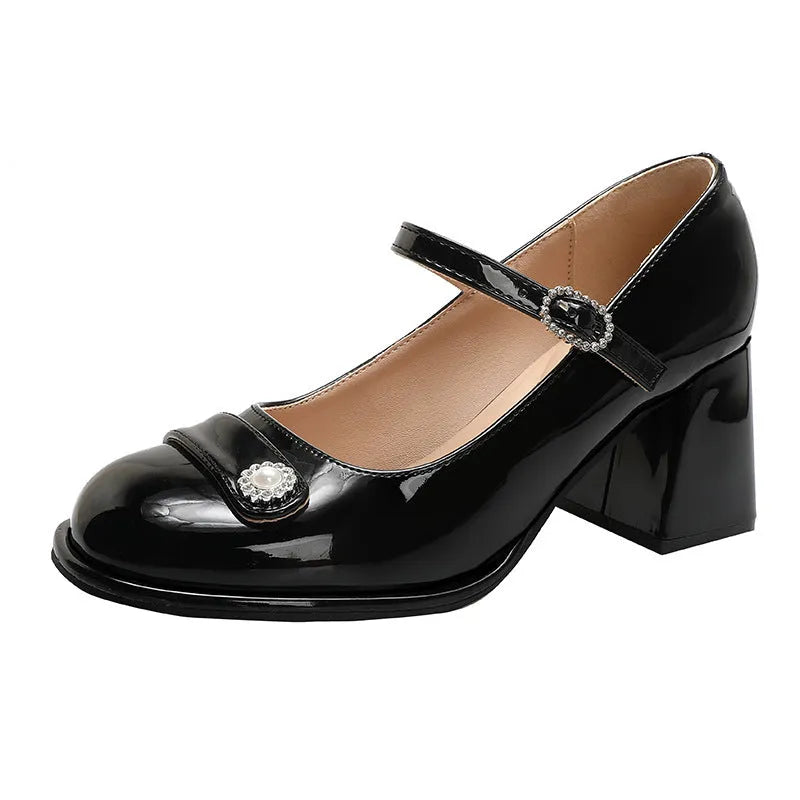 Black patent leather women's chunky heel shoes with round toe and buckle fastening.