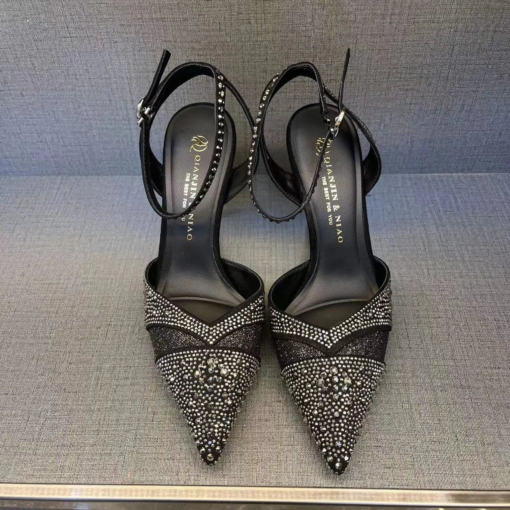 Women's black and silver hollow-cut stiletto high heels with pointed toes and red soles.