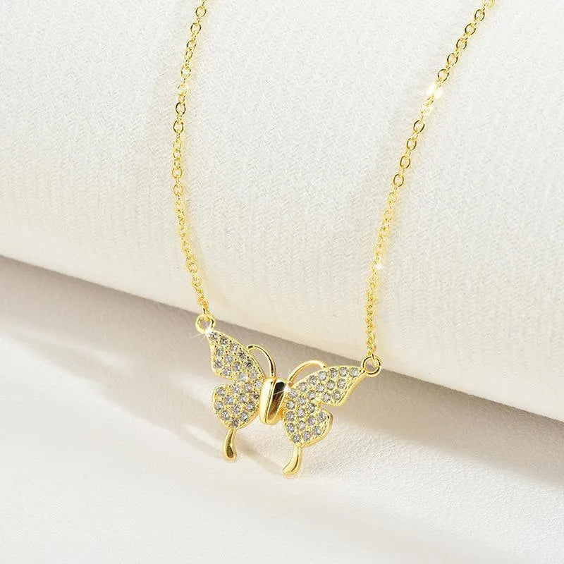 Gold titanium steel necklace with butterfly pendant on twisted chain and magnetic clasp.