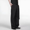 Black loose-fit straight-leg trousers with a single pleat and adjustable mid waist on a hanger.