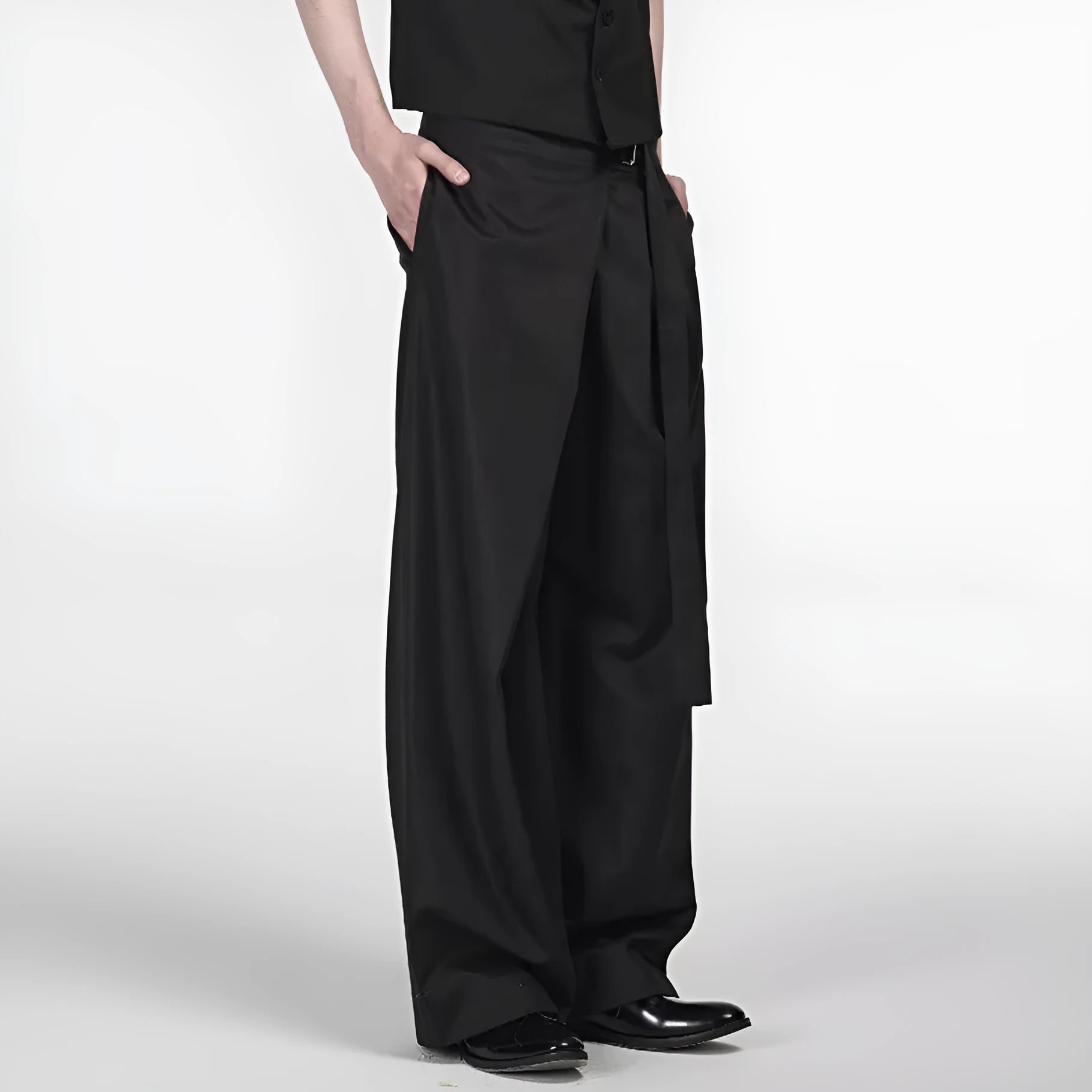 Black loose-fit straight-leg trousers with a single pleat and adjustable mid waist on a hanger.