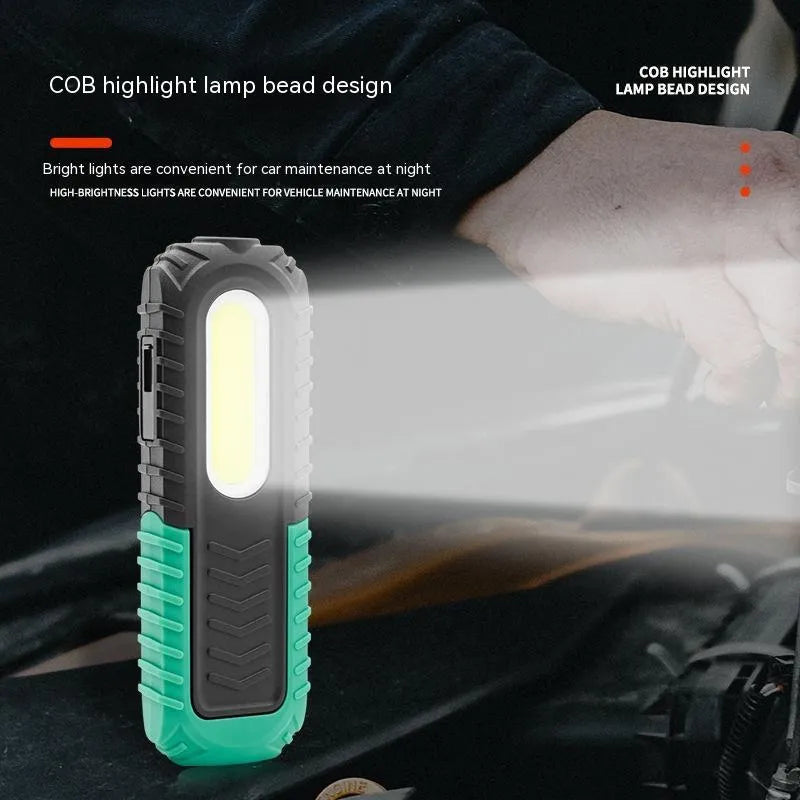 Black and green auto repair work light with USB charging cable for vehicle maintenance