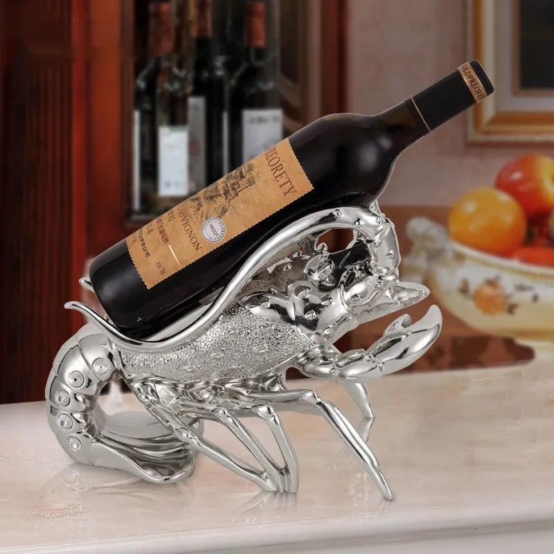 Lobster-shaped wine rack ornament in rose gold or silver, holding a wine bottle.