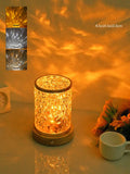 Rotating water ripple night light with acrylic body and solid wood base projecting colourful light patterns