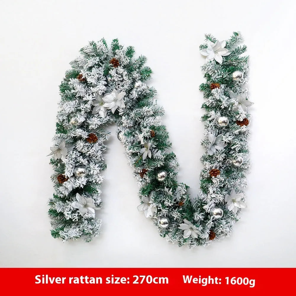 Flocked PVC rattan vine Christmas garland decoration in a festive colour, draped over a mantelpiece.