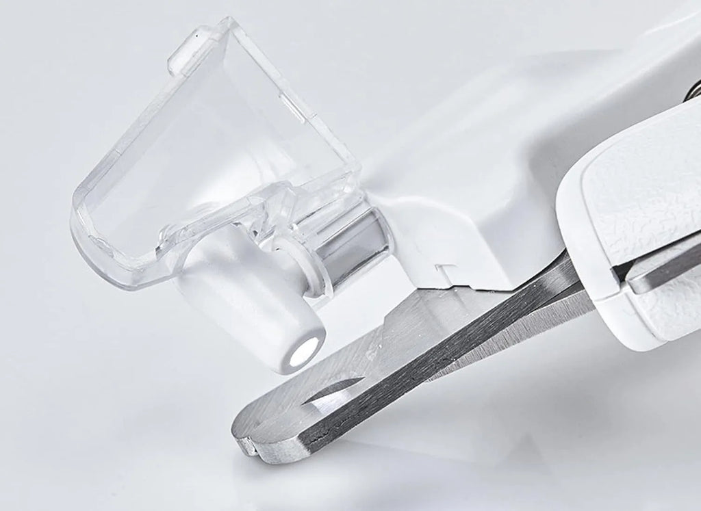White LED pet nail clippers with transparent guard open, showing triangular steel blades and a nail file.