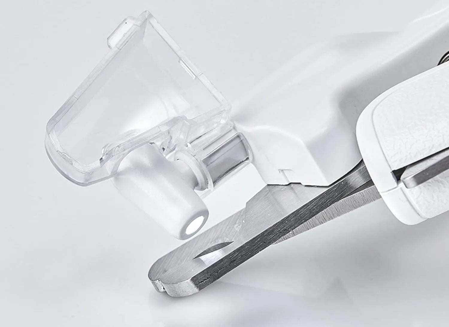 White LED pet nail clippers with transparent guard open, showing triangular steel blades and a nail file.