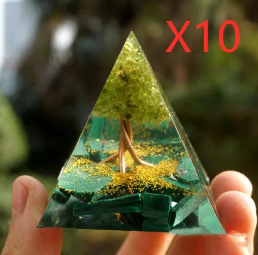 A small 6cm clear resin pyramid decoration with natural crystal gravel inside, on a neutral background.