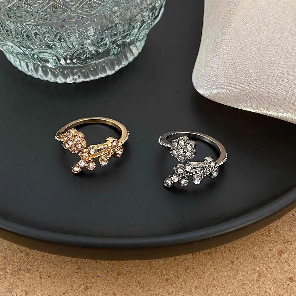 Women's open ring with diamond treatment flower leaves design in gold or white colour