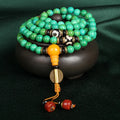 Natural turquoise bracelet with 108 round 8mm beads on wrist showing polished stone texture