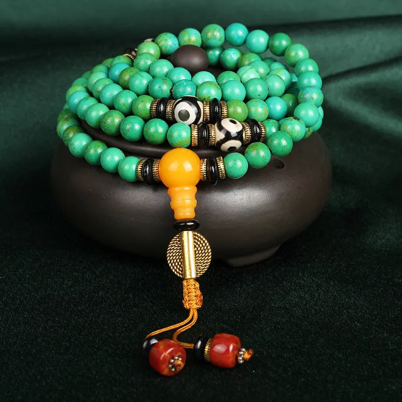 Natural turquoise bracelet with 108 round 8mm beads on wrist showing polished stone texture