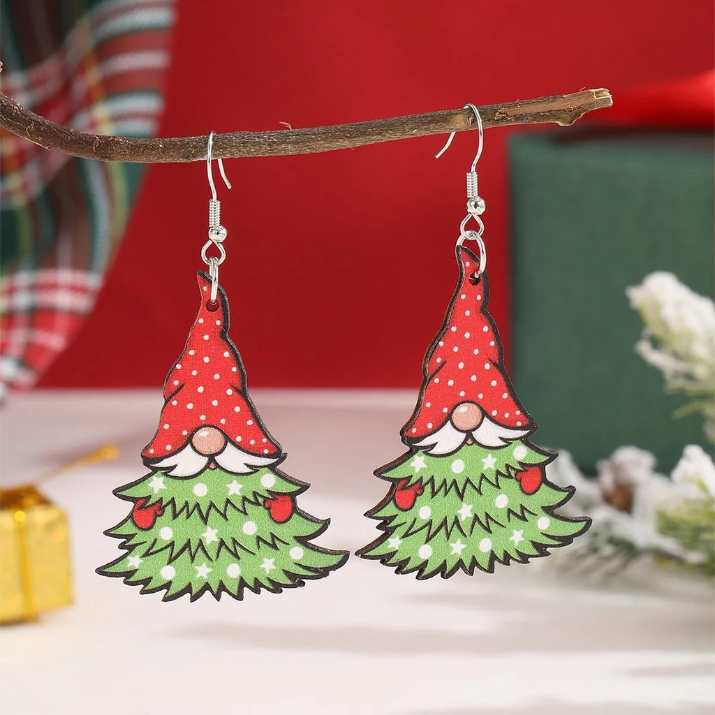Wooden Christmas earrings with geometric shapes showing printed tree and snowman designs