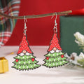 Wooden Christmas earrings with geometric shapes showing printed tree and snowman designs