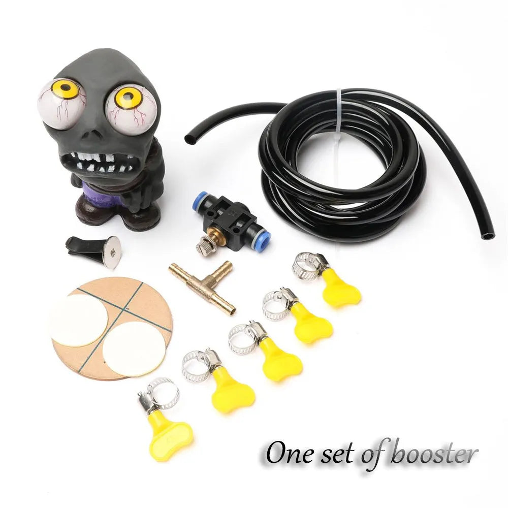 Turbo car blow-off valve ornament kit showing rubber doll, copper tube, pressure valve, and tubing on a car vent.