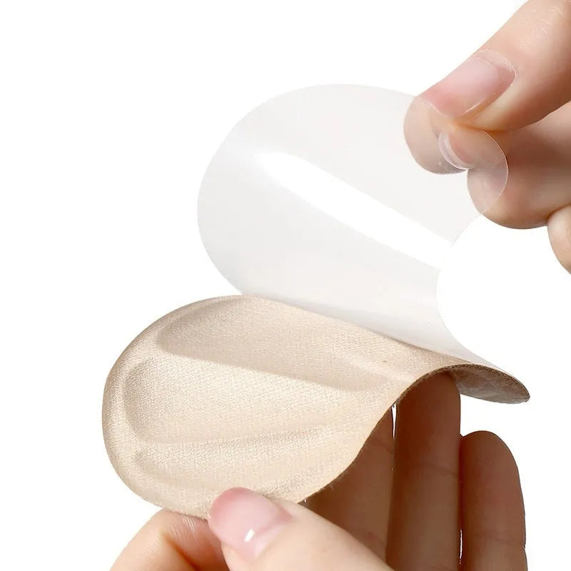 Three pairs of camel-coloured suede heel cushion pads with adhesive backing, each measuring 9.3x6cm