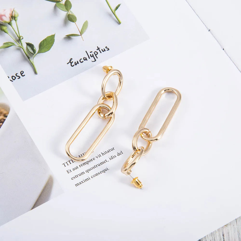 Geometric sterling silver needle colour hoop drop earrings with ring and line design on a white background.
