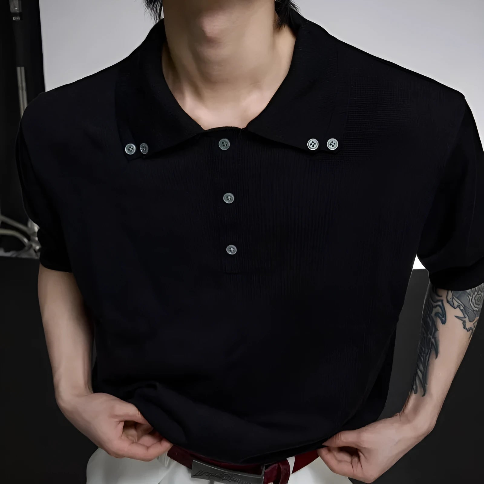 Man wearing a grey slim-fit short sleeve knit shirt with a double lapel collar design.