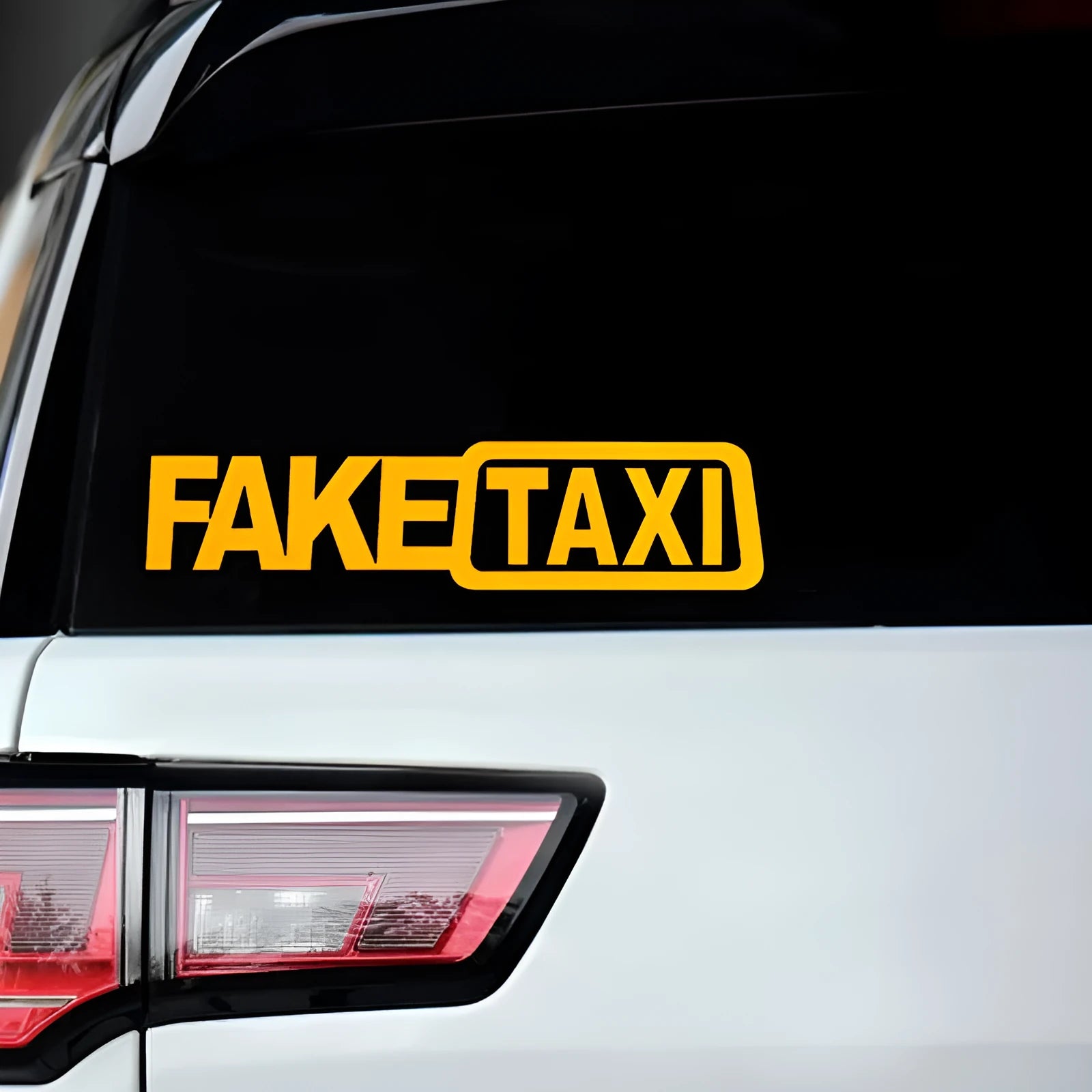 Yellow Fake Taxi waterproof car sticker on a vehicle window, showing 20cm by 8cm size.