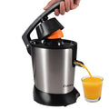 Stainless steel manual citrus juicer with round feeding port for lemons and oranges.