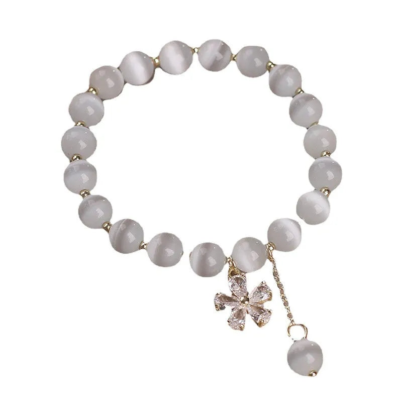 Women's white cat's eye crystal bracelet with flower tassels and safety buckle