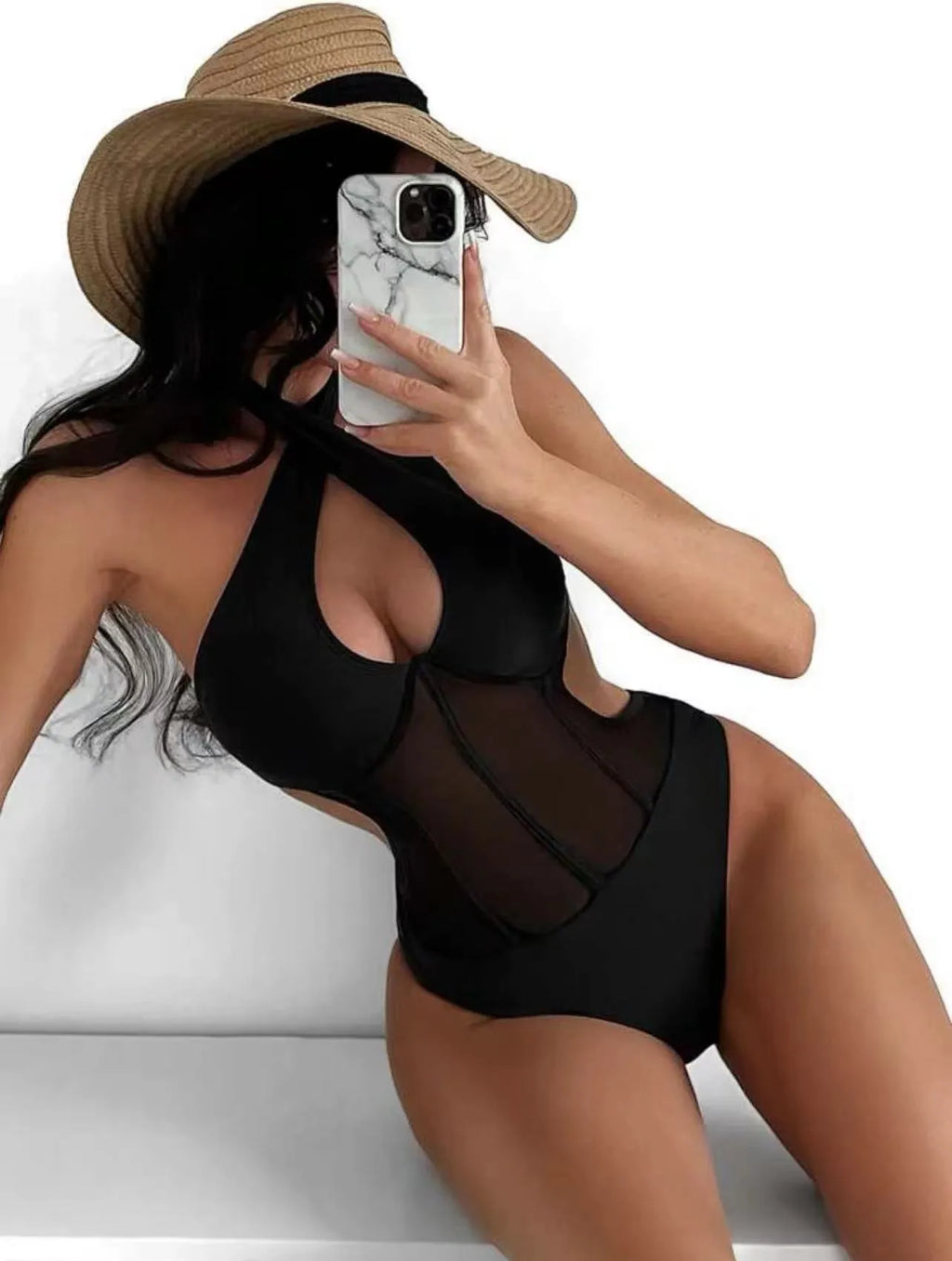 A black ladies one-piece swimsuit bikini made from nylon and spandex fabric on a mannequin.