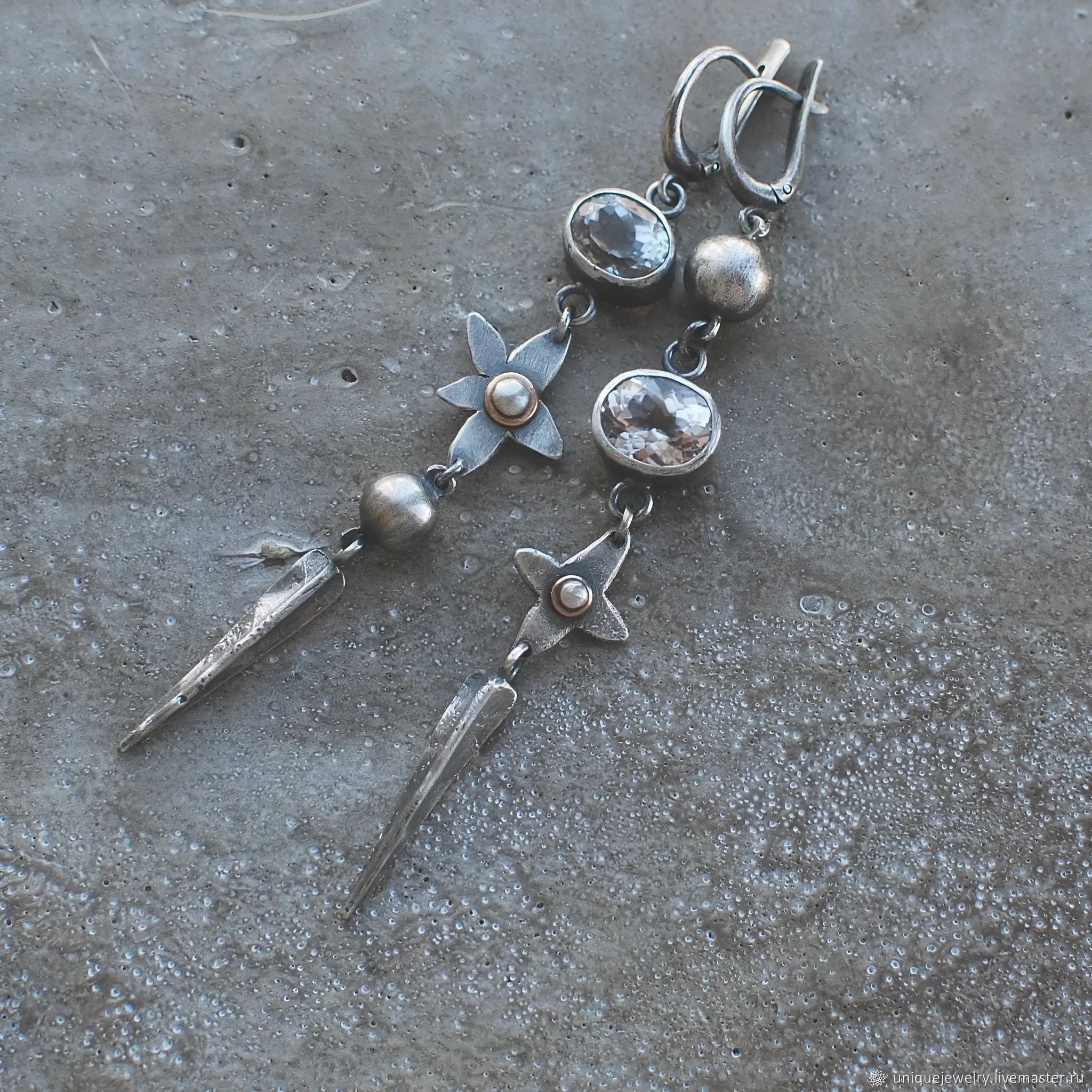 Geometric long pendant earrings in antique silver with rhinestone details on a stud.