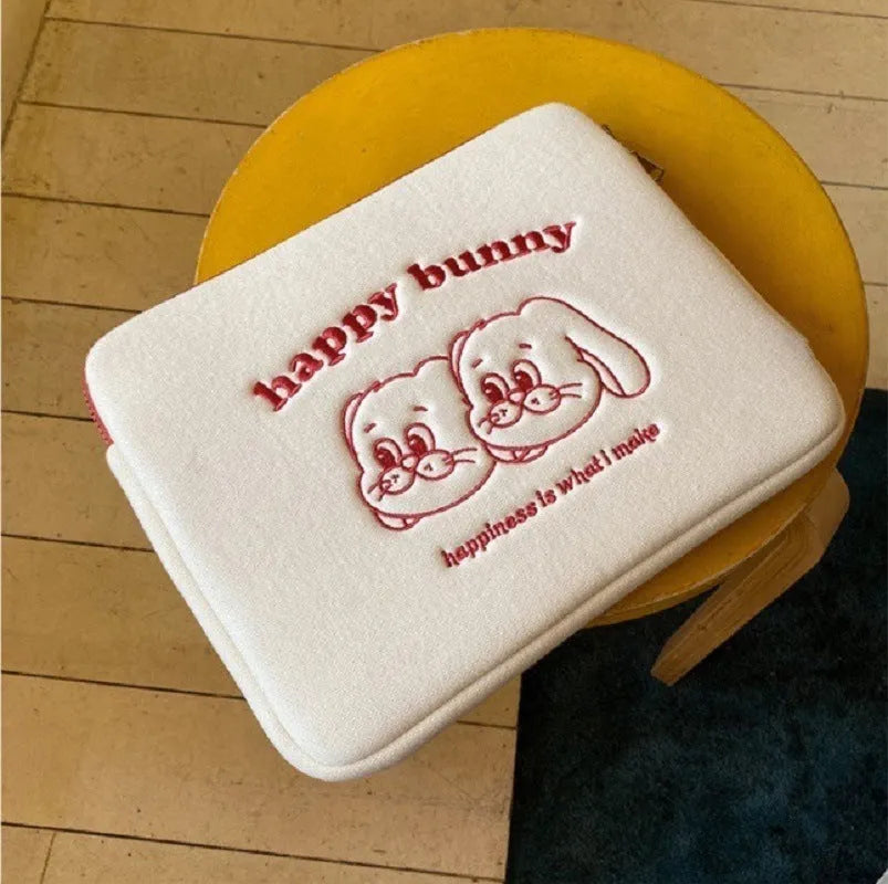 Embroidered laptop sleeve with animal design showing polyester construction and laptop size compatibility