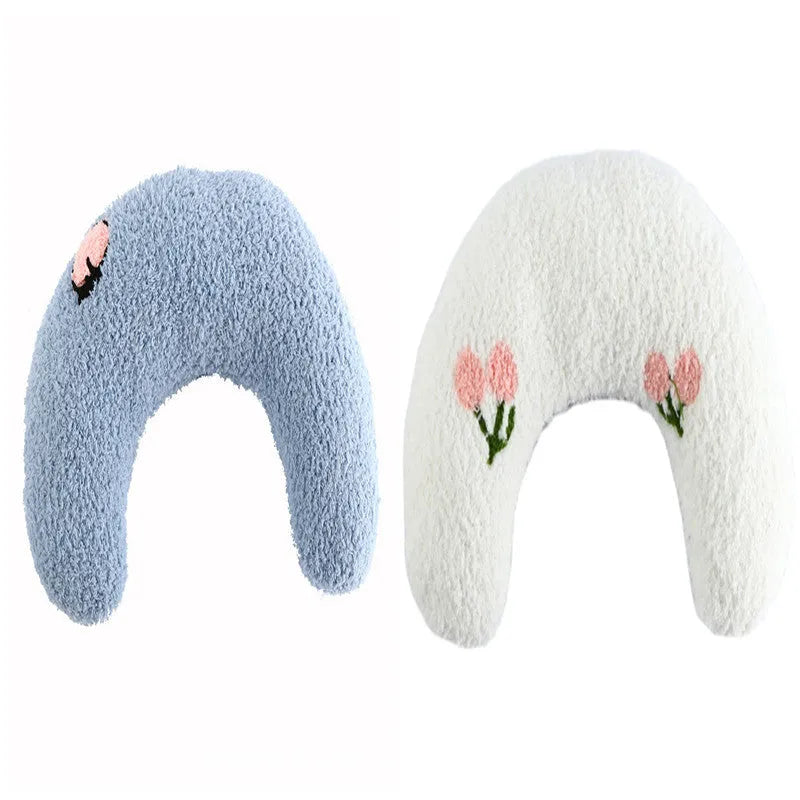 Small U-shaped plush pillow for cats and small dogs in blue colour, showing quilted faux fur texture.