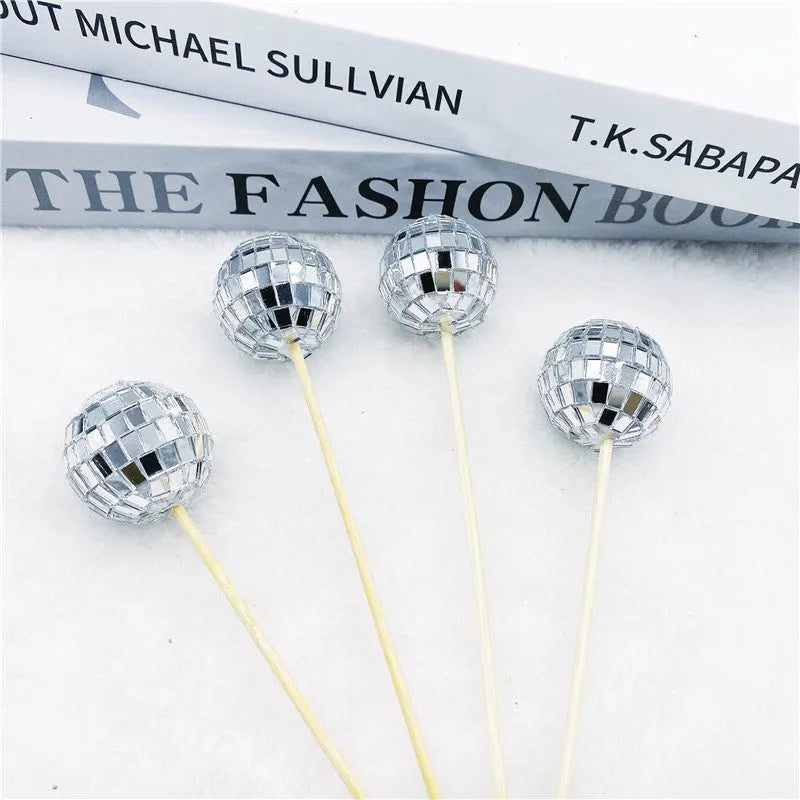 Glass disco ball cake decoration with wooden stick on a birthday cake