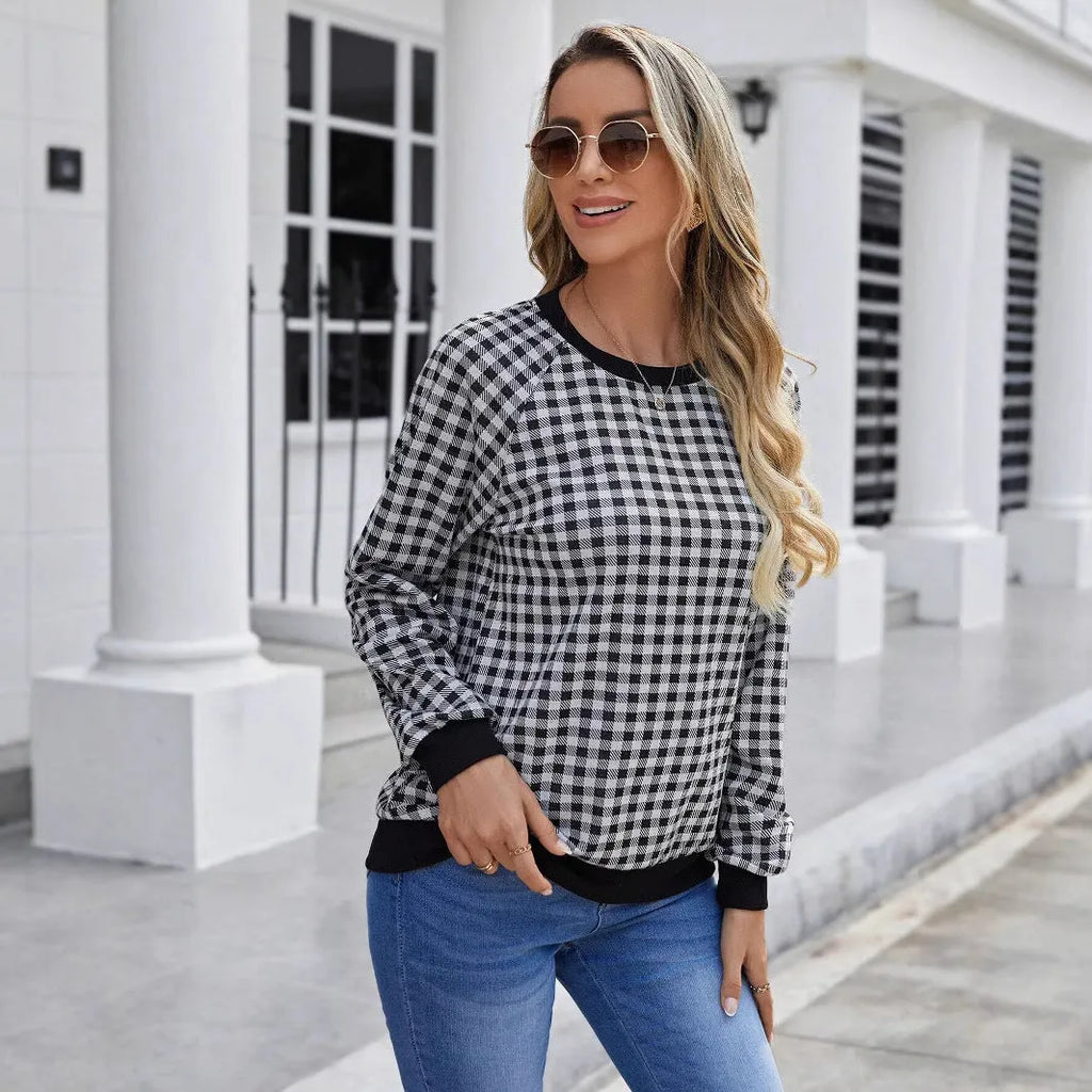Black polyester pullover sweater with a plaid printed pattern and long sleeves.