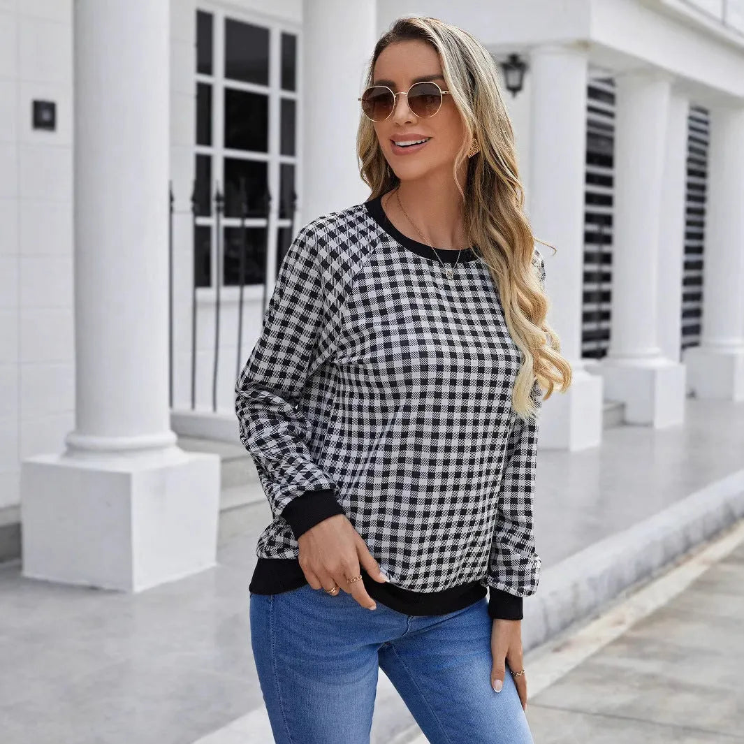 Black polyester pullover sweater with a plaid printed pattern and long sleeves.
