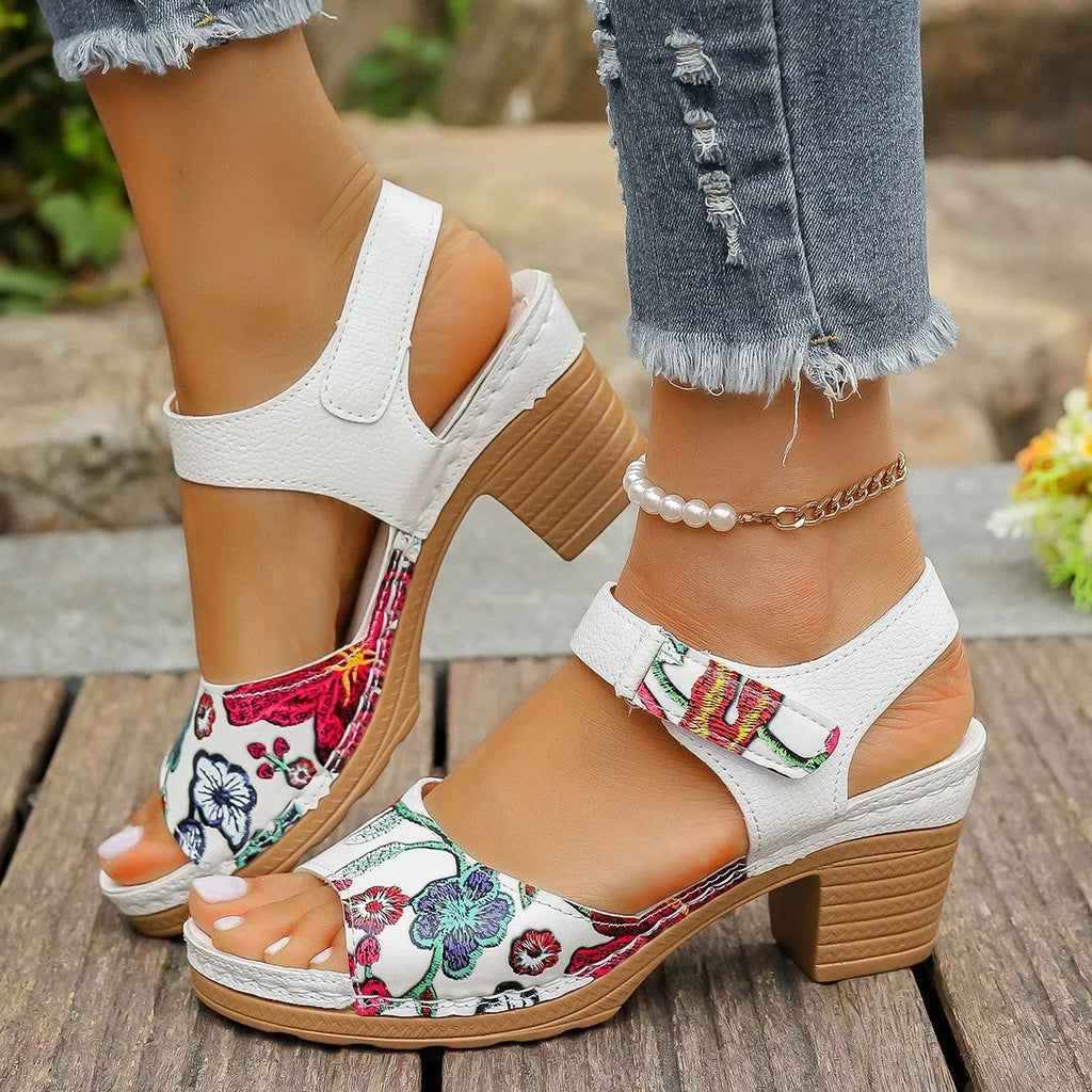 White women's high heel sandals with a Velcro strap fastener on a casual rubber sole.