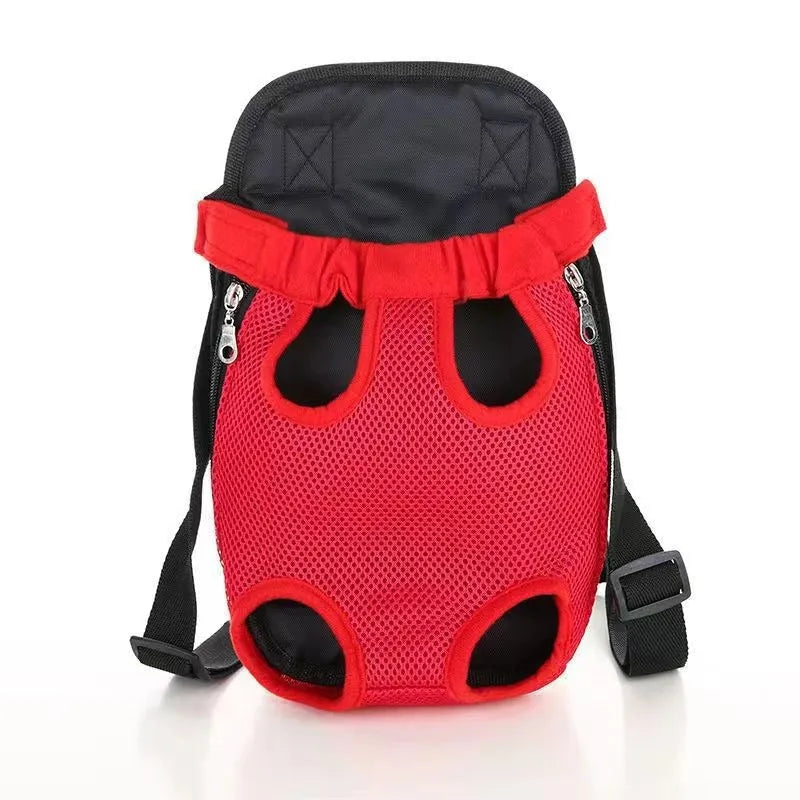 A person wearing a black nylon dog carrier backpack on their chest, containing a small dog looking out.