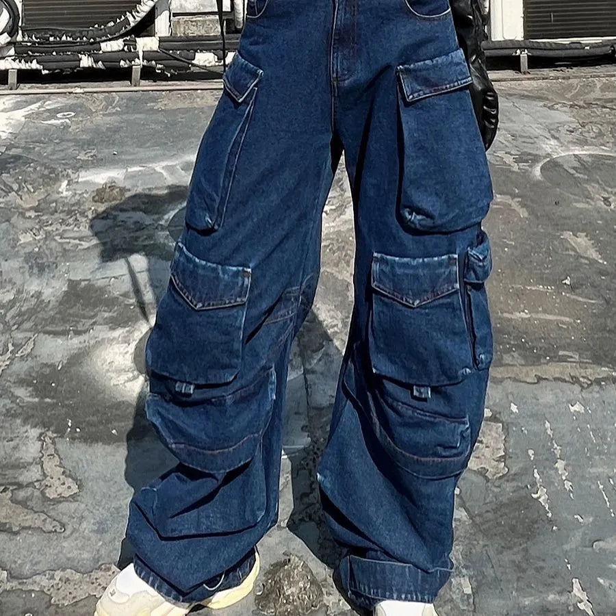 Dark blue distressed wide-leg jeans with high waist, multiple pockets, and raw hem detail