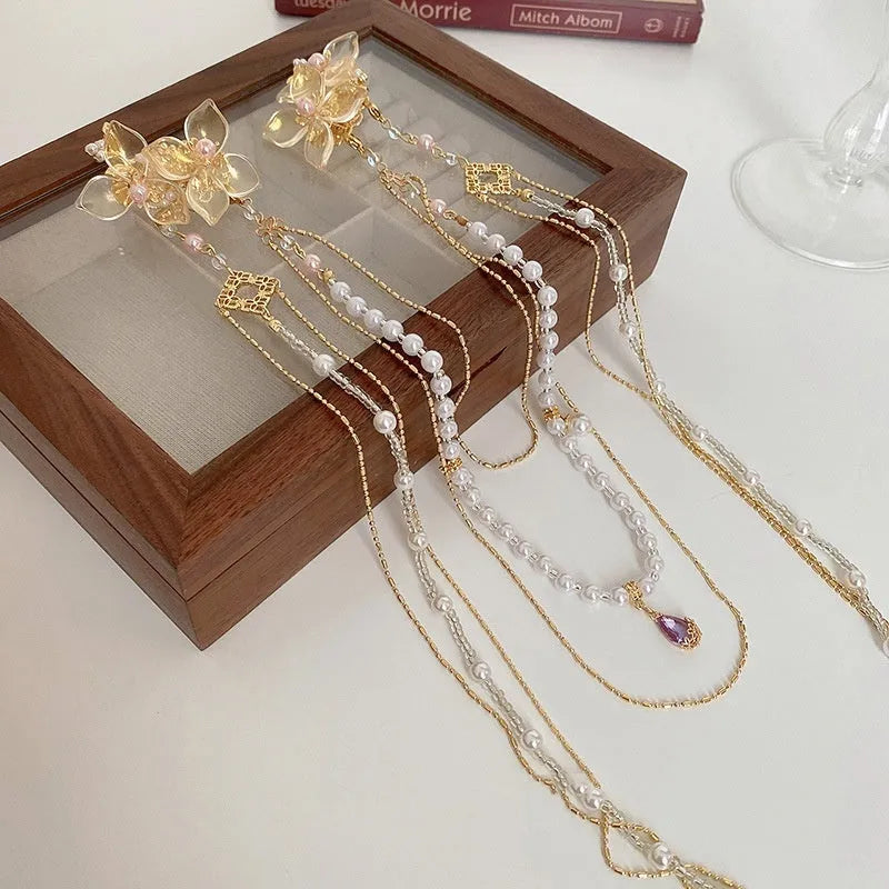 Gold women's hairpin with diamond flower design and long acrylic tassels